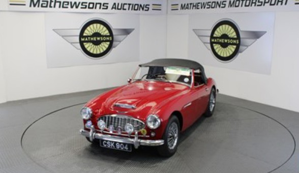 A classic red sports car on the Mathewsons turntable, of the kind sold at a Mathewsons classic-car auction