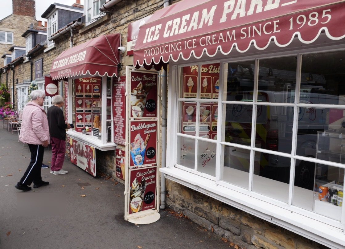The Baldersons Ice Cream Parlour, with a red awning reading Producing ice cream since 1985