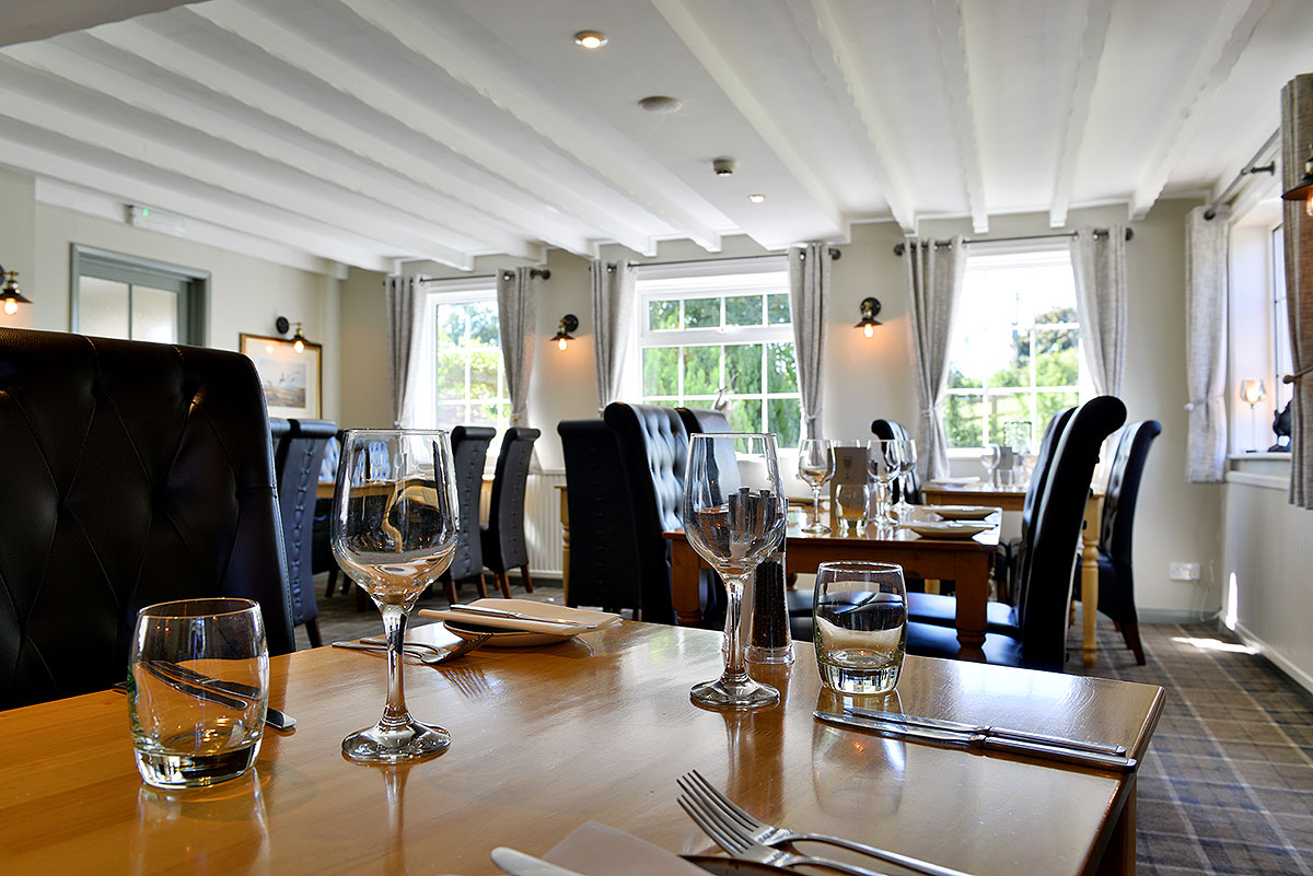 Tables laid for lunch in the light restaurant at the Cayley Arms