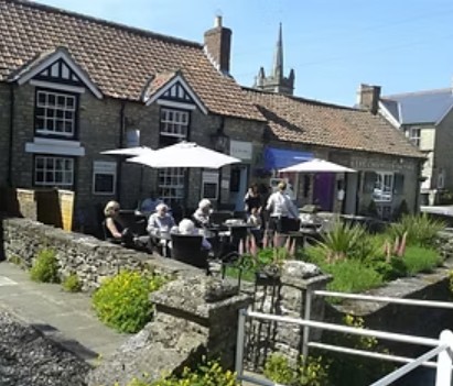 Tea and cake served outside a tea room beside Thornton Beck in Thornton-le-Dale