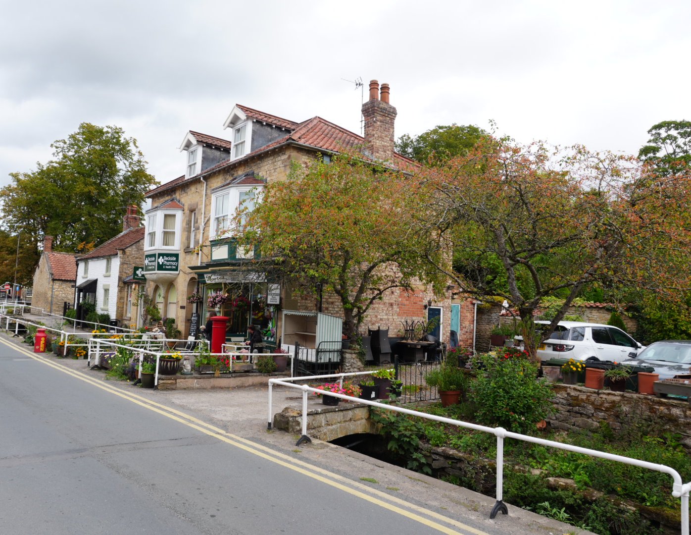 Maltongate in Thornton-le-Dale beside Thornton Beck, looking towards Beckside Pharmacy